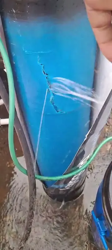Water jetting from the crack in the Aquaguard water softener and pooling on the floor